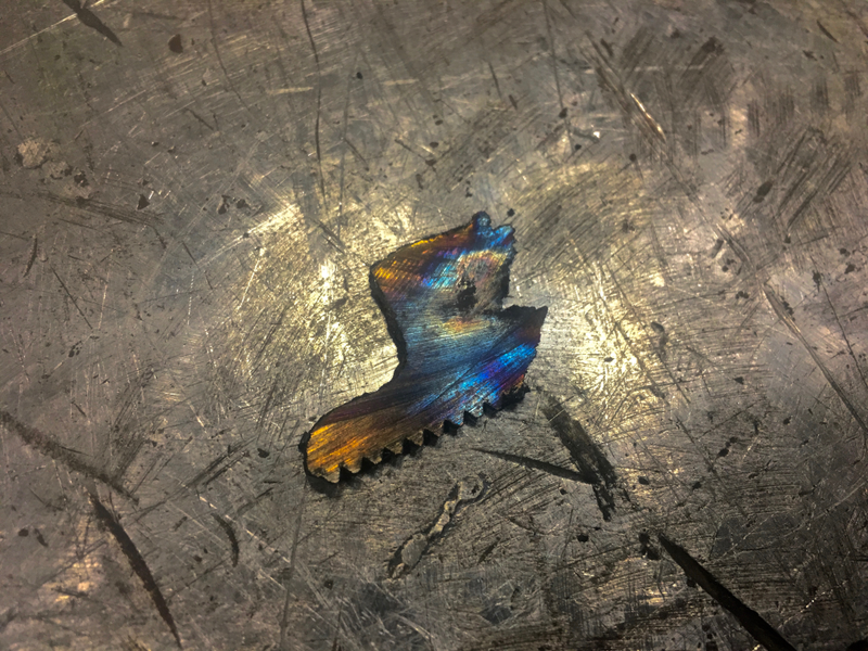 A small chip that fell from a bearing that had to be cut from it’s shaft.